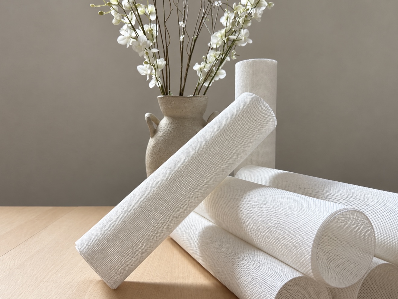 Blank needlepoint canvas rolls in the studio